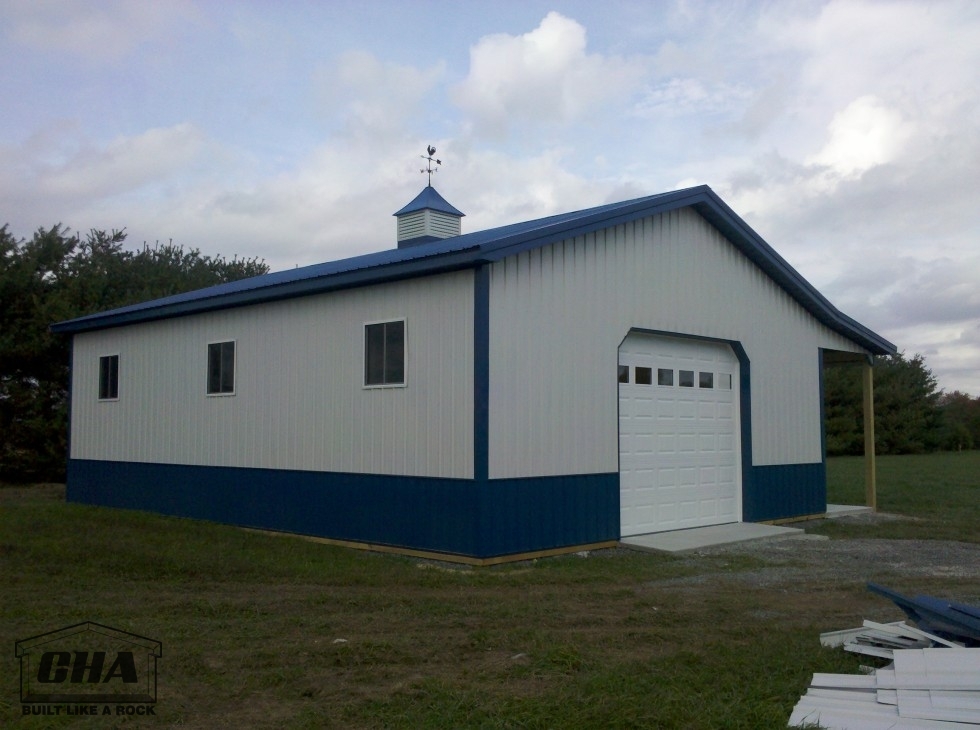 blue and white pole building with sliding windows
