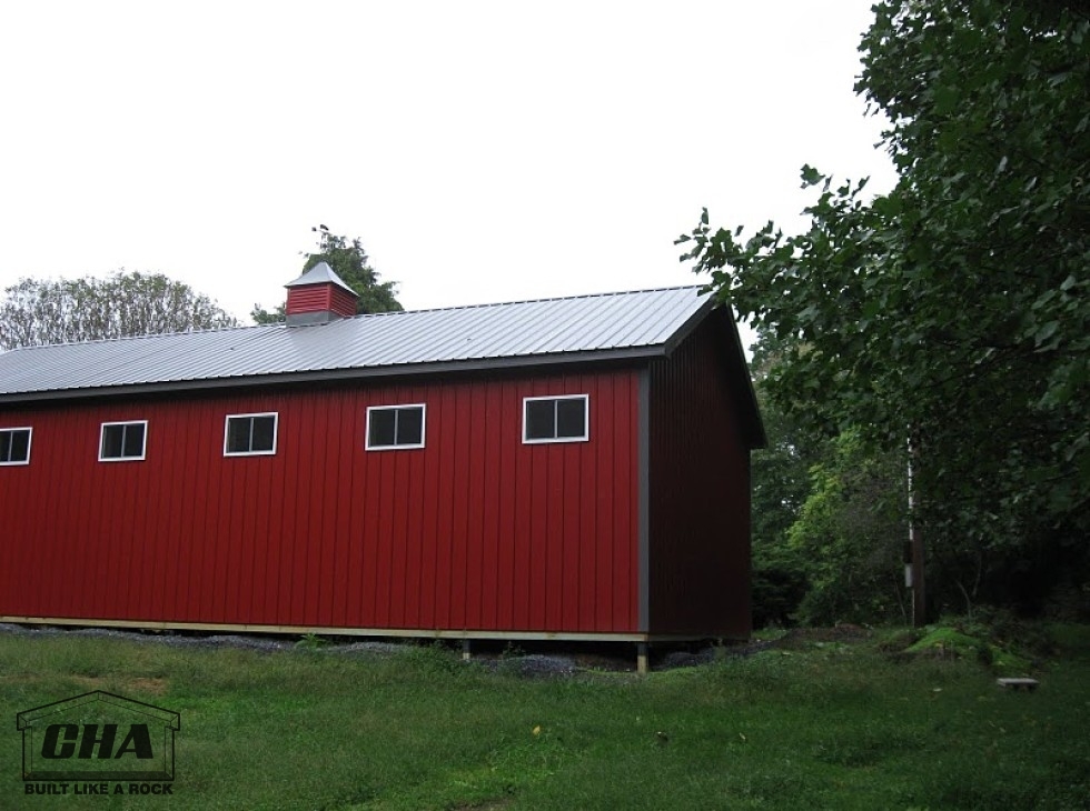red pole barn showing three windows