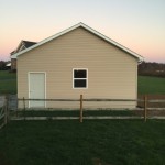 small pole barn with siding, windows, and doors