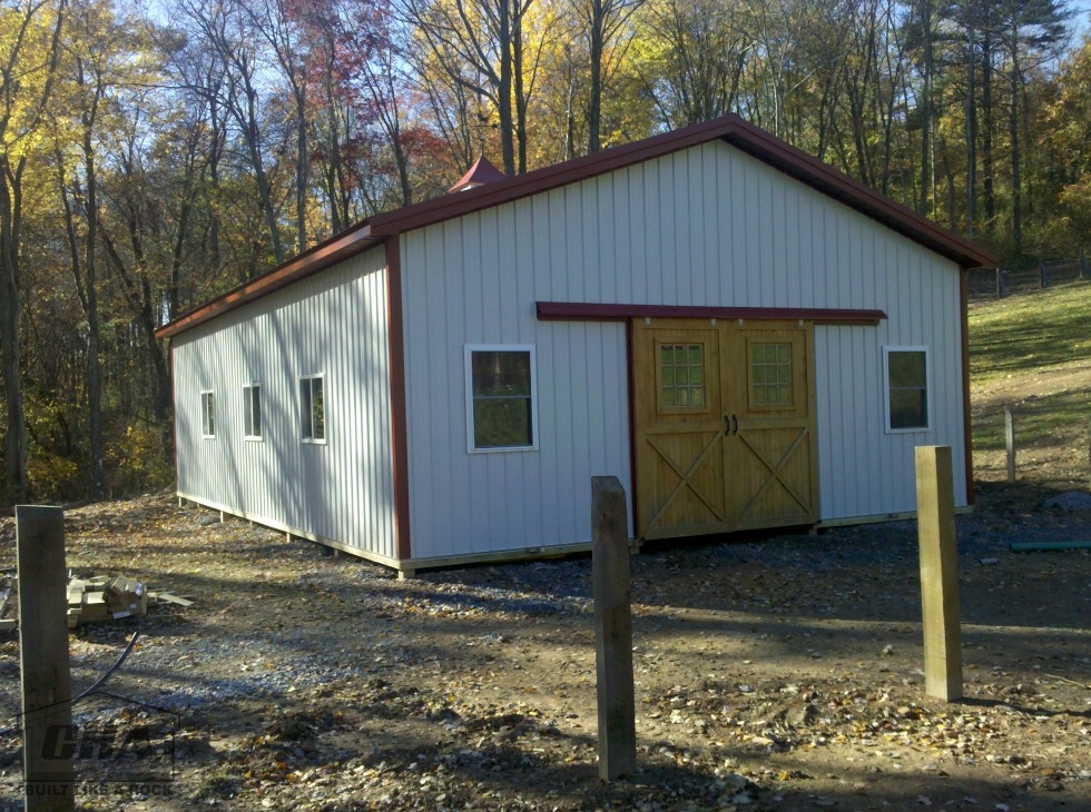pole barn with windows and sliding wood door