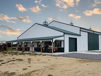 a large white and green commercial farm building